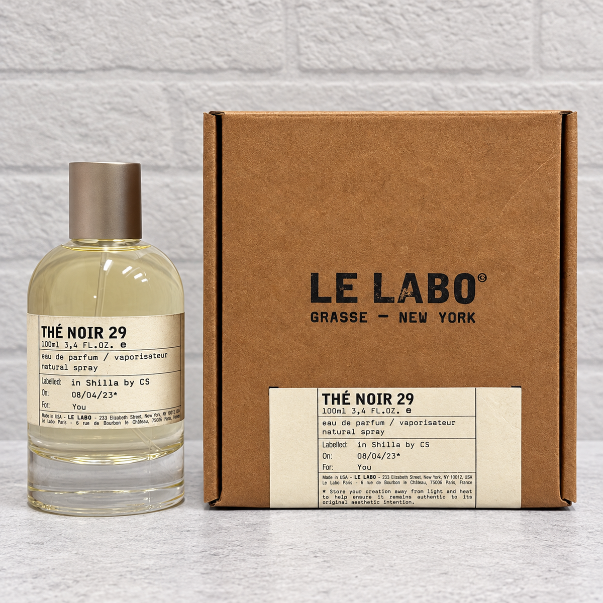 Thé Noir 29 100 mL open box, approximately five sprays missing — front view