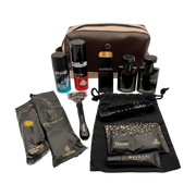 Grooming kit with various items including a bag, bottles, and a razor on a white background